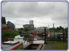 Boats along the canal under a rain filled sky