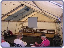 Tent erected and screen for slides of yard to be shown